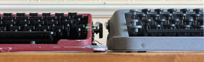 1950 Gossen Tippa and 1952 Hermes Baby typewriters front views side-by-side